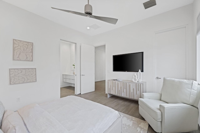 bedroom with ceiling fan, hardwood / wood-style flooring, and ensuite bathroom