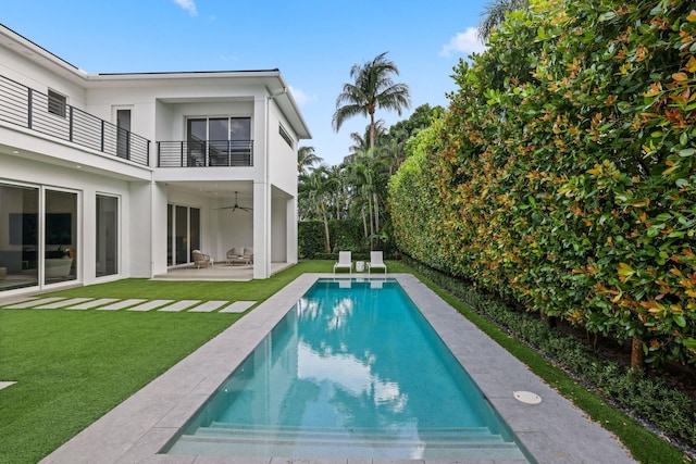 view of pool with a lawn and a patio area