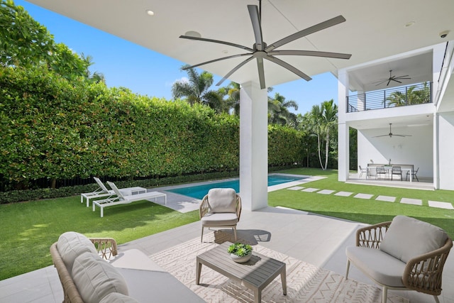 view of patio featuring outdoor lounge area, ceiling fan, and a fenced in pool