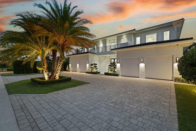 view of front facade featuring a balcony and a garage