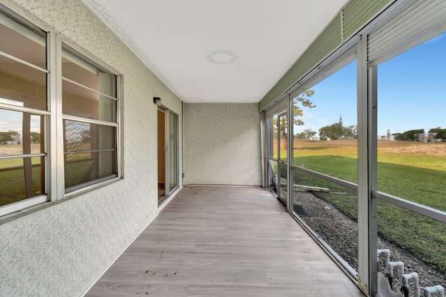 spare room featuring dark wood-style floors and baseboards
