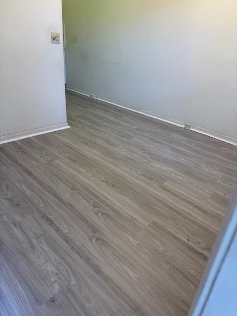 unfurnished room featuring dark hardwood / wood-style floors