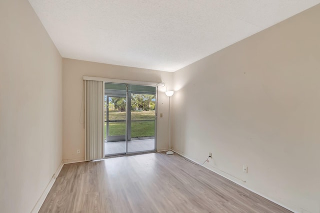 empty room with light wood-style flooring and baseboards