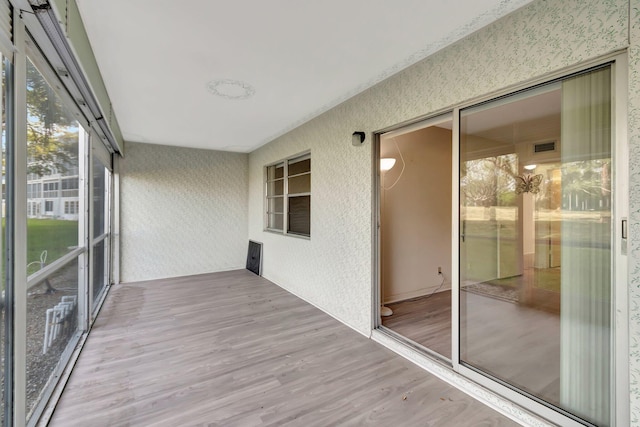 unfurnished sunroom featuring wood finished floors