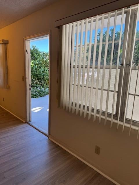 doorway featuring hardwood / wood-style floors and a textured ceiling