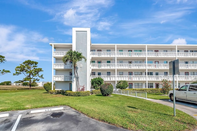 view of apartment building / complex with uncovered parking