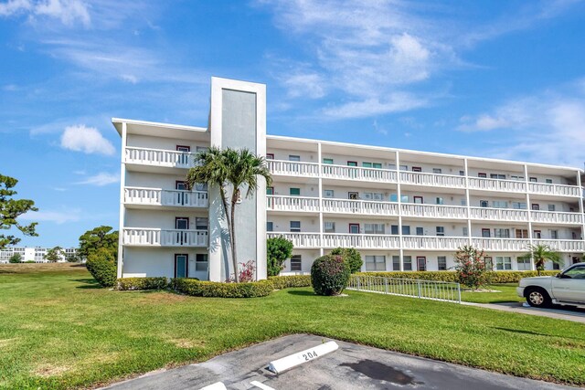 view of apartment building / complex featuring uncovered parking
