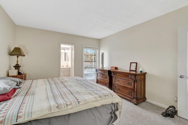 carpeted bedroom with ensuite bath