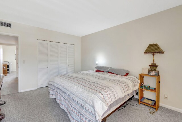 bedroom featuring light colored carpet and a closet