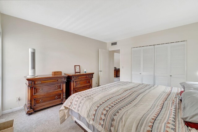 bedroom featuring a closet and light carpet