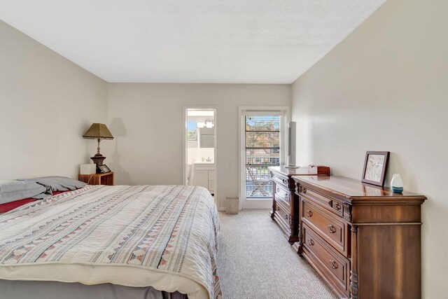 bedroom featuring connected bathroom and light colored carpet