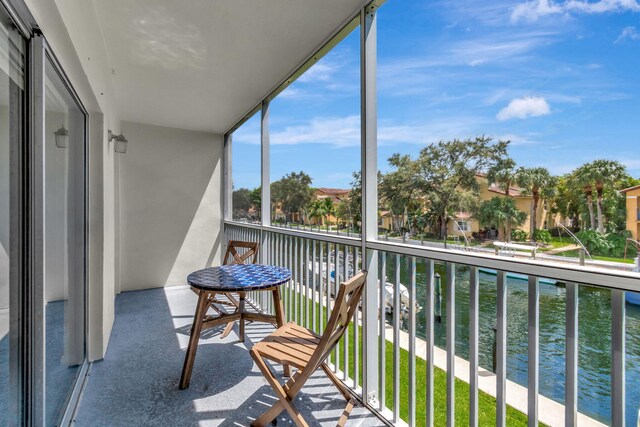 balcony featuring a water view