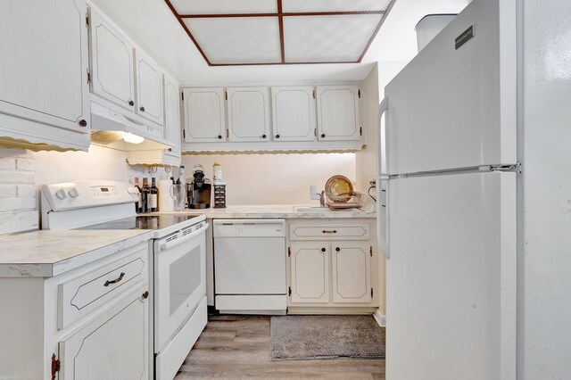 kitchen featuring light wood-type flooring, white appliances, and white cabinetry