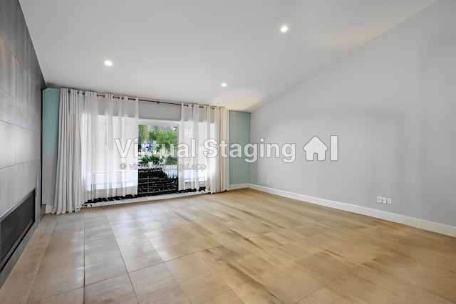 empty room featuring recessed lighting and baseboards