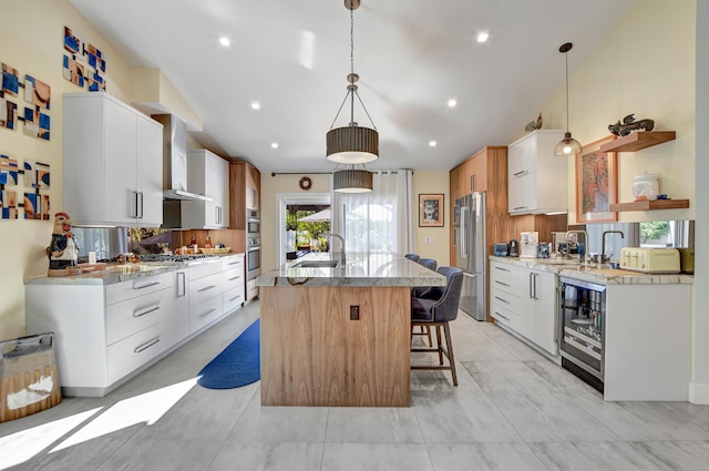 2951 San Remo Way, Delray Beach, FL 33445 - kitchen with appliances with stainless steel finishes, modern cabinets, beverage cooler, an island with sink, and a breakfast bar