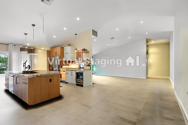 kitchen with a kitchen island with sink, dishwasher, modern cabinets, and a sink