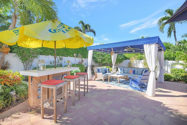 view of patio with a fenced backyard, a pergola, outdoor dry bar, and an outdoor hangout area