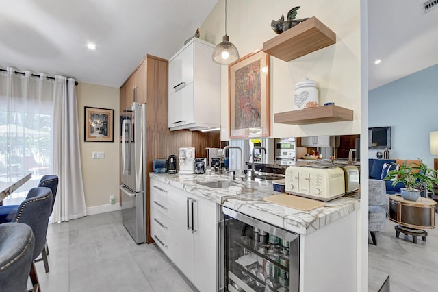 2951 San Remo Way, Delray Beach, FL 33445 - kitchen with freestanding refrigerator, open shelves, a sink, wine cooler, and white cabinetry