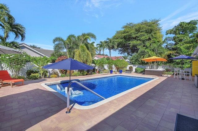 pool with fence and a patio area