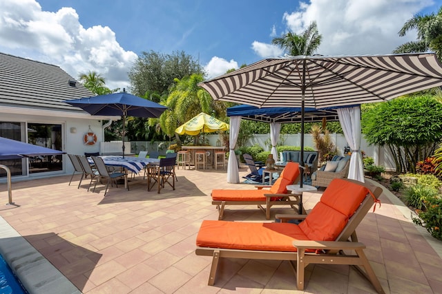 view of patio / terrace with outdoor dining area, a fenced backyard, and outdoor dry bar