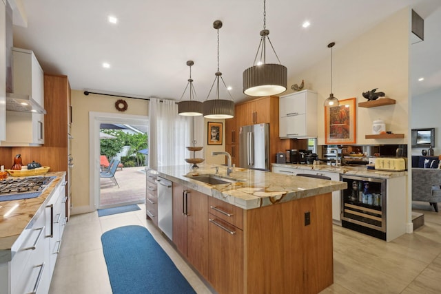 kitchen featuring a sink, stainless steel appliances, open shelves, and beverage cooler