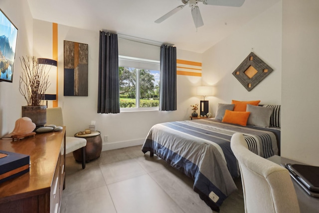 tiled bedroom featuring baseboards and ceiling fan