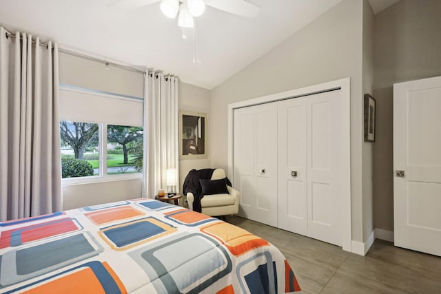 bedroom featuring a closet, lofted ceiling, baseboards, and a ceiling fan