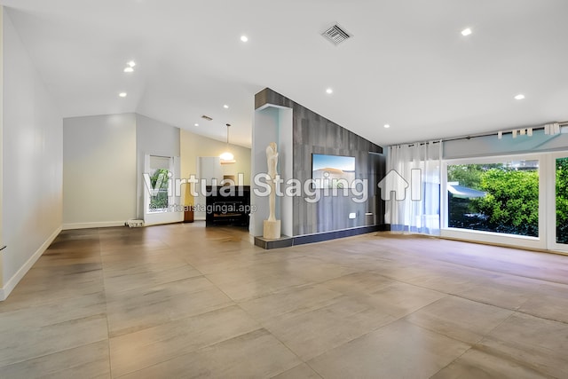 unfurnished living room with high vaulted ceiling, recessed lighting, visible vents, and baseboards