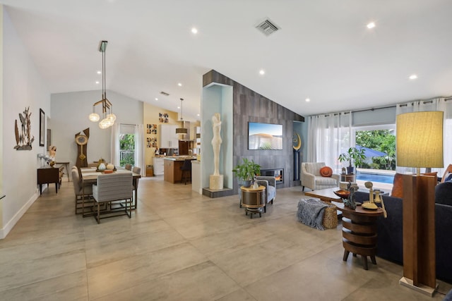 living room with recessed lighting, visible vents, high vaulted ceiling, and a healthy amount of sunlight