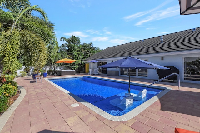 outdoor pool with a patio and fence