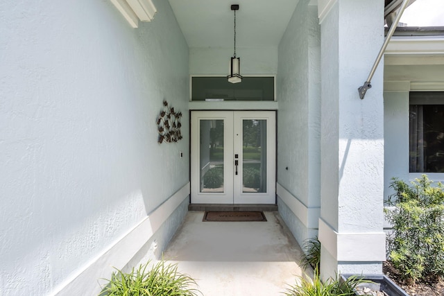 entrance to property with stucco siding and french doors