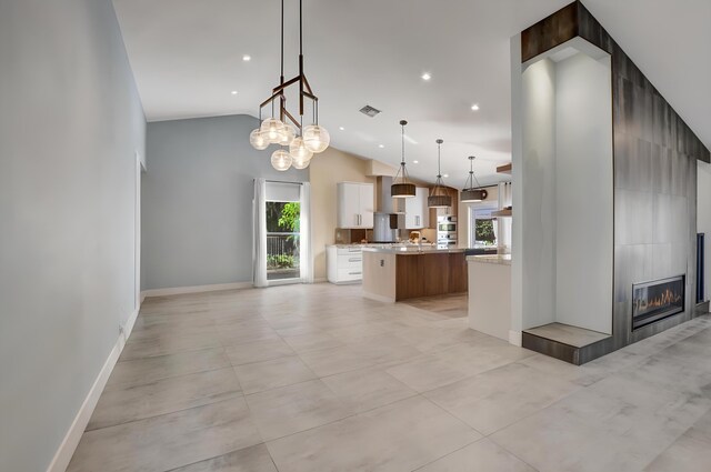 2951 San Remo Way, Delray Beach, FL 33445 - kitchen featuring a large island, open floor plan, baseboards, a fireplace, and hanging light fixtures