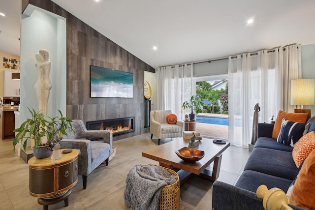 living area with light tile patterned floors, a large fireplace, recessed lighting, and vaulted ceiling