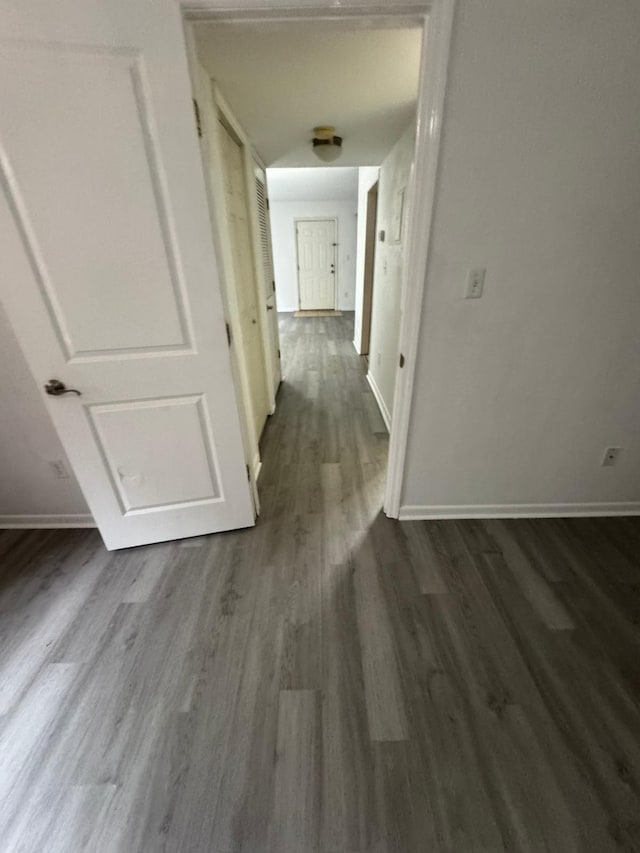 hallway with dark wood-type flooring