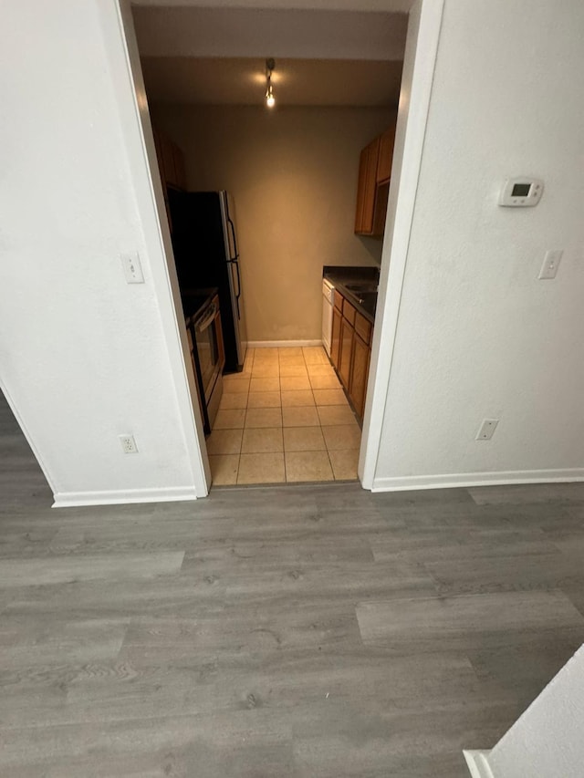 kitchen featuring stainless steel range with electric cooktop and light tile patterned flooring