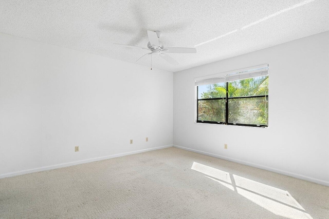 unfurnished room with carpet, ceiling fan, and a textured ceiling