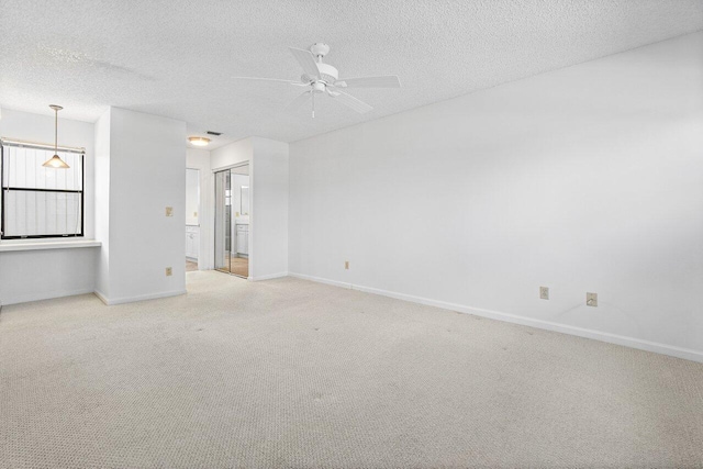 carpeted empty room with a textured ceiling and ceiling fan