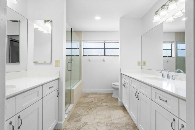 bathroom with vanity, toilet, and an enclosed shower