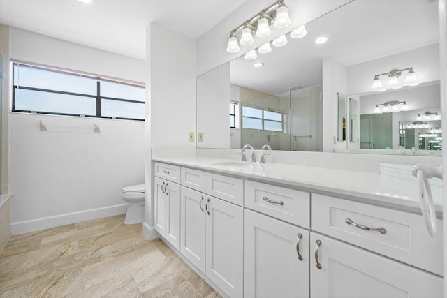 bathroom with vanity, toilet, and a shower with shower door