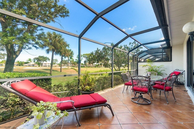 view of patio featuring a lanai