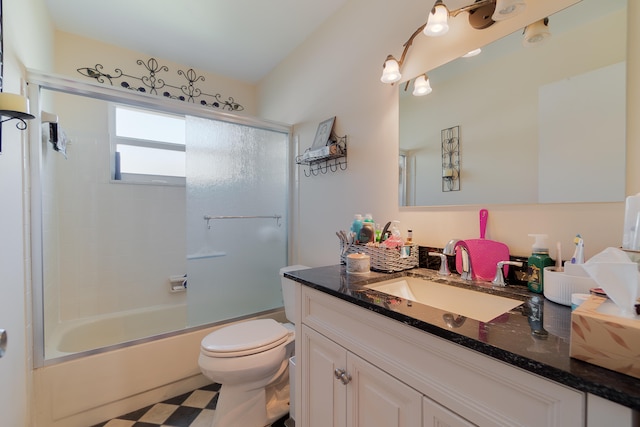 full bathroom with toilet, vanity, and bath / shower combo with glass door