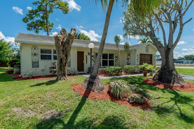 ranch-style home with a garage and a front yard