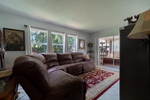 living room featuring light tile patterned floors and a textured ceiling