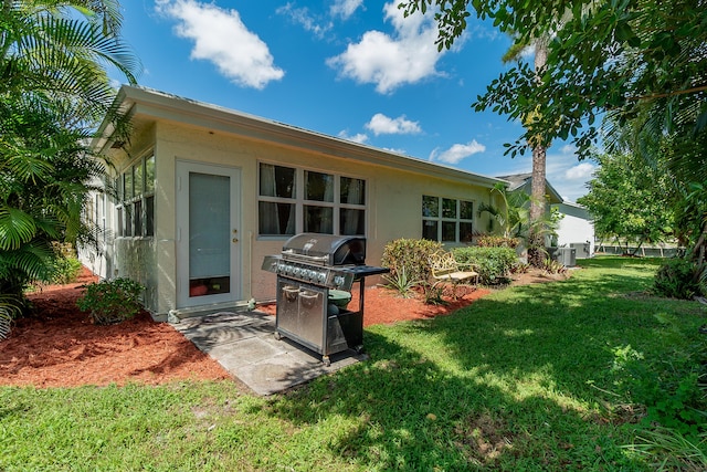 rear view of property with a yard