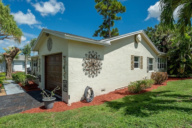 view of side of property with a garage and a yard