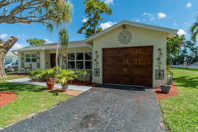 ranch-style house with a garage and a front lawn