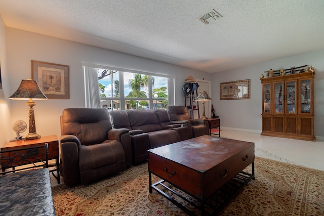 living room featuring light tile patterned floors and a textured ceiling