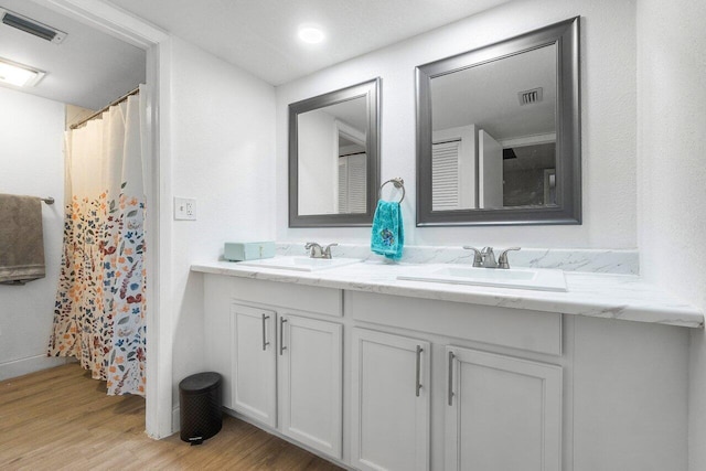 bathroom with hardwood / wood-style flooring and vanity