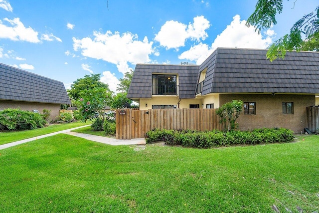 rear view of property with a yard