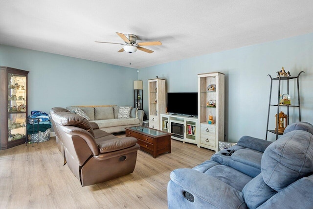 living room featuring a textured ceiling, light hardwood / wood-style flooring, and ceiling fan